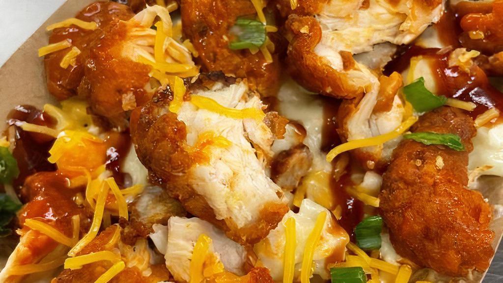 Bbq Buffalo Chicken Mac · A mix of yellow and white mac, a BBQ drizzle, topped with buffalo Chicken and a sprinkled shredded cheese and green onion. Served with a piece of Cornbread!