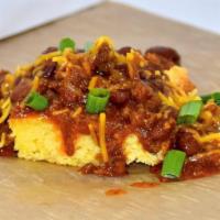 Smothered Cornbread · Cornbread smothered with our homemade chili topped with cheese and green onion