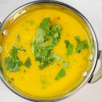 Tarka Dal · Yellow lentils cooked in butter and lightly topped with fresh garlic.