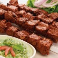 Seekh Kebab · Minced ground lamb mixed with fresh herbs and spices, formed into skewers, and served sizzli...