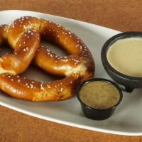 Bavarian Pretzel · Hand twisted, salted and baked to order. Served with housemade warm queso and honey mustard ...