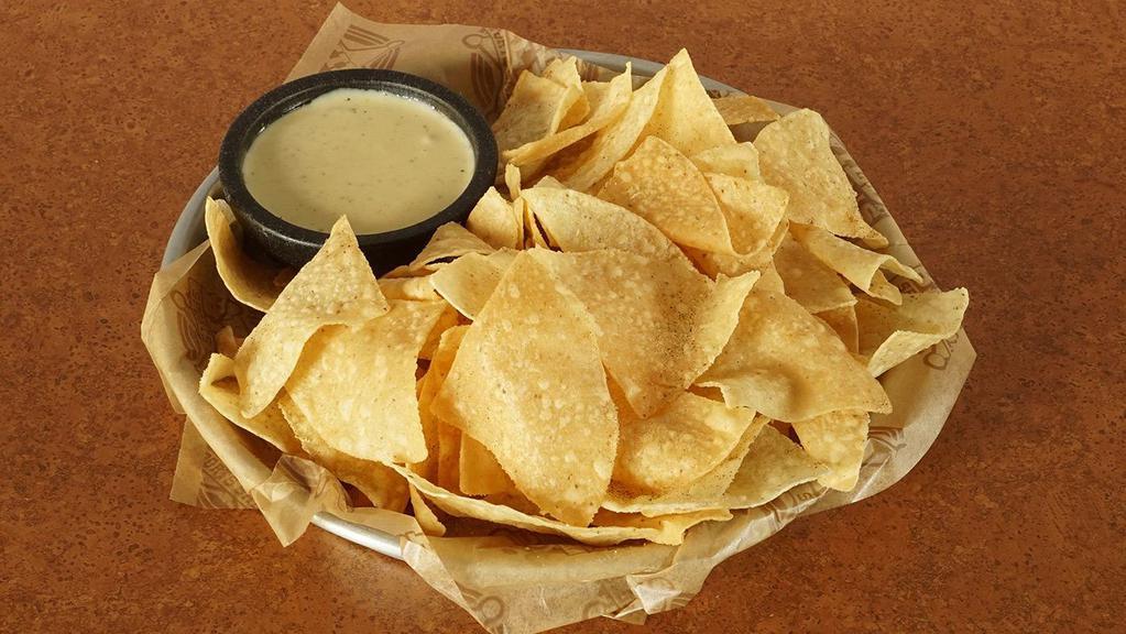 Chips & Queso · Fresh tortilla chips dusted with our southwest seasoning, warm housemade queso and pico de gallo garnish.