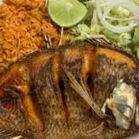 Mojarra Frita · Fish tilapia deep fried served with rice, beans, salad and tortillas. Flour or corn tortilla...