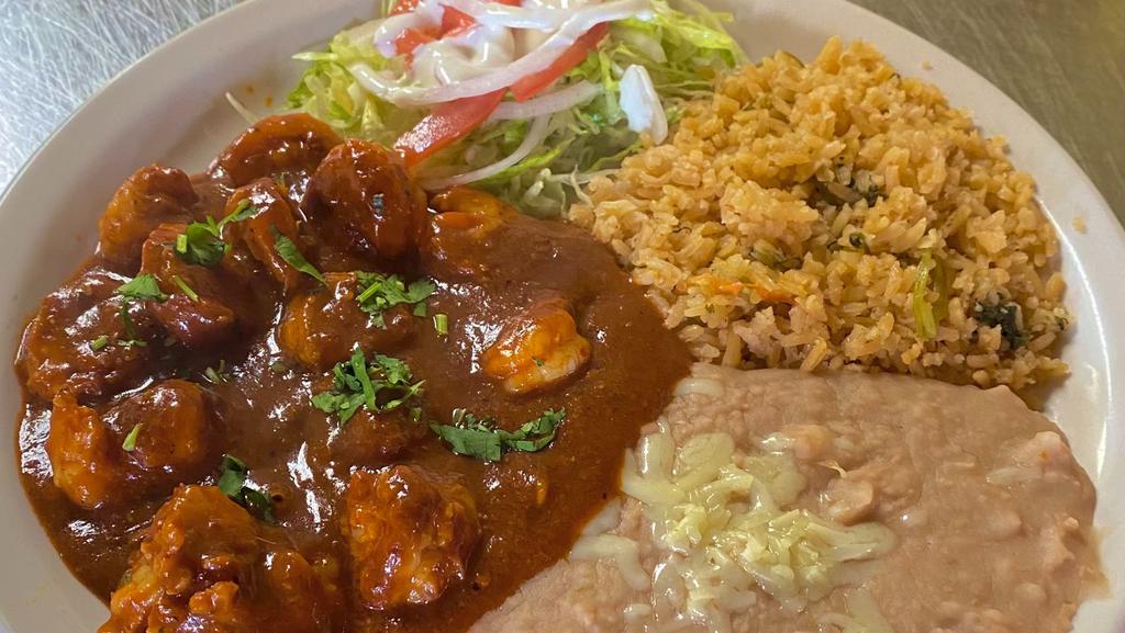 Camarones A La Diabla · Grilled shrimp with a spicy sauce, served with rice, beans, lettuce, tomatoes, onions, avocado, and tortillas. Flour or corn tortillas your choice.