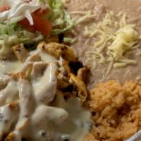 Choripollo  · Grilled chicken with chorizo sausage, topped with cheese sauce. Served with beans, rice, and...