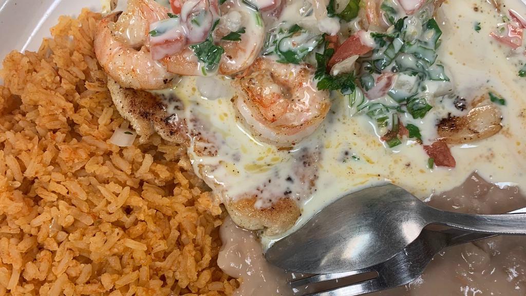 Pollo Jerez · Grilled chicken breast topped with shrimp and Pico de Gallo. Topped with cheese sauce. Served with beans, salad, rice, and tortillas. Your choice of flour or corn tortillas.