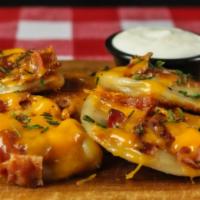 Loaded Baked Potato Pierogi Skillet · Served with five pierogi topped with bacon, cheddar cheese, and chives.