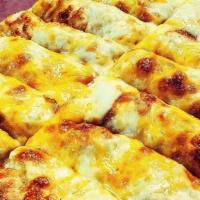 Cheese Bread · Hand stretched pizza dough, topped with mozzarella, parmesan, cheddar cheese & garlic. Serve...
