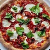 Margherita Pizza · Tomato sauce, oven-dried tomatoes, fresh mozzarella, hand torn basil, extra virgin oil.