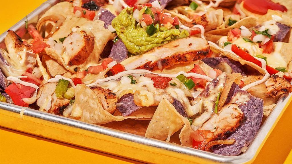 Fajita Nachos · Chips topped with your choice of Fajita Chicken or Fajita Steak, queso, melted jack cheese, grilled peppers and onions, pico de gallo, house crema, and guacamole.