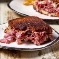 Signature Reuben · Housemade corned beef, sauerkraut, Swiss, and 1000 isle, on grilled marbled rye, with fries....