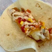 Halibut Taco · Crispy breaded Halibut, Fresh mango pico de gallo, and Key lime jalapeño sauce