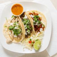 Tacos · Topped with cilantro and onion.