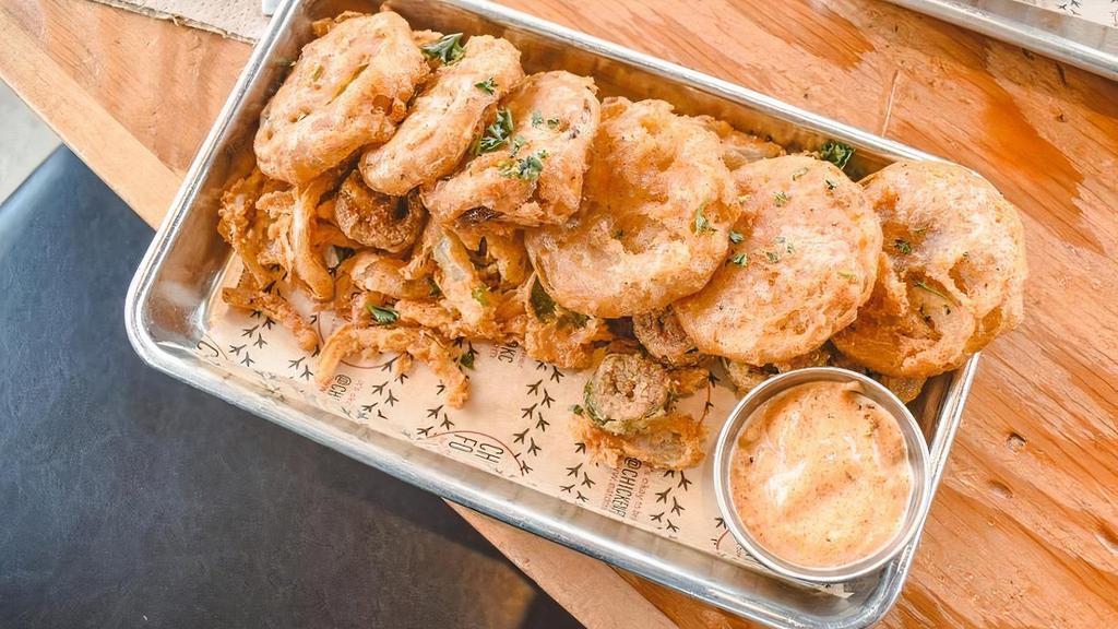 Fried Green Tomatoes · Hand-breaded, Green Tomatoes served w. Fried Jalapeños, Onions, & Southwest Remoulade.