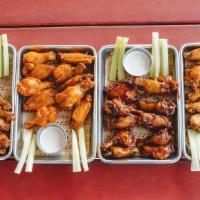 Wings · 10 Bone-In Wings Tossed in a Sauce of Your Choice or Dry Rub. Served with Choice of Ranch or...
