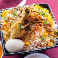 Hyderabad Chicken Dum Biryani · Chicken and basmati rice cooked in layers, flavored with saffron, served with raita and mirc...