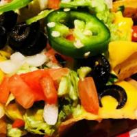 Nachos · Crispy chips topped with Cheddar cheese sauce, Lettuce, tomatoes, onions, black olives, jala...