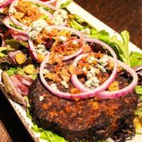Berry Beany Nutty Salad · Black bean patty on top of a bed of spring mix, topped with dried cranberries, crumbled Bleu...