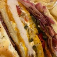 Cluck Norris Chicken Sandwich · Huge Chicken sandwich topped with candied jalapenos, cream cheese, cheese, and bacon in a fr...