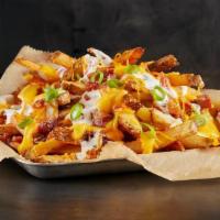 Bacon Cheddar Ranch Fries · Fresh-Cut Fries seasoned with salt and pepper. Loaded with bacon, cheddar cheese, green onio...
