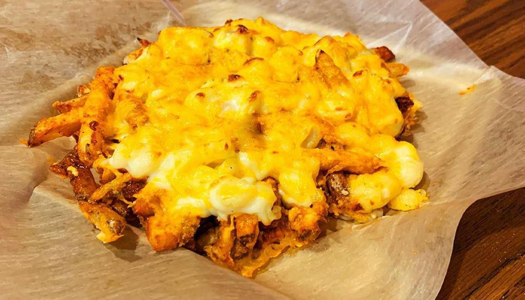 Three-Cheese Buffalo Mac Fries · Fresh-Cut Fries seasoned with salt and pepper. Loaded with . tangy buffalo sauce, Pepper Jack Mac 'n Cheese, golden cheddar, then oven-baked and topped again with Parmesan cheese