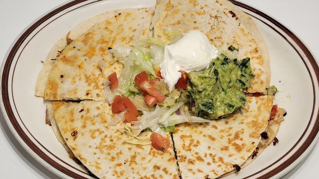 Special Quesadilla · Grilled chicken or steak 8 inch tortilla served with lettuce, tomatoes, guacamole, and sour cream.