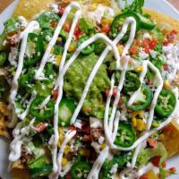 Nachos Supremos  · Nachos with chicken, ground beef and black beans. Topped with cheese dip, romaine mix, diced...