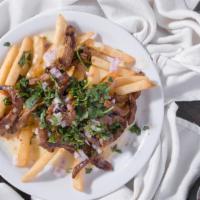 Asada Fries · Full size order of french fries topped with carne asada, cheese dip, red onions, and cilantr...