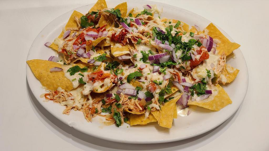 Nachos  · corn tortilla chips topped with your choice of protein
chicken, Beef, or beans  with cheese on top

*Chicken is mixed with veggies
*Beef is mixed with carrots & potatoes
*Beans have onions & jalapenos