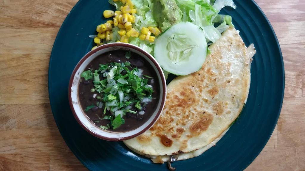 Fresh Spinach And Mushroom Quesadilla · Grilled fresh spinach and mushroom quesadilla, romaine mix, guacamole, corn, and cucumber slices. Served with black beans.