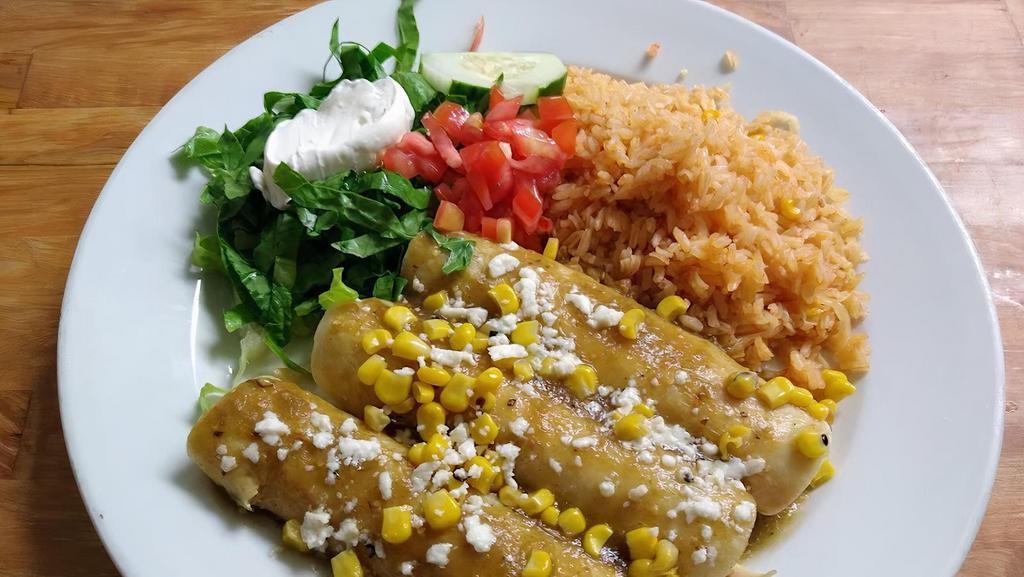 Enchiladas Suiza · Three chicken enchiladas topped with green sauce, queso fresco, and corn. Served with rice, romaine mix, sour cream, and tomatoes.