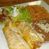 Chimichanga Supremas · Two deep fried tortillas filled with chicken or shredded beef. Served with rice, black or re...