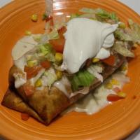 Big Mama Chimichanga · A large flour tortilla filled with either shredded chicken or ground beef, rice, black or re...