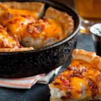 Loaded Pizza Skins · Deep dish pizza crust filled with mashed potatoes, bacon and cheddar. Sour cream on the side