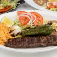 Carne Asada · Outer skirt steak cooked to your specification and served with grilled peppers onions a piec...