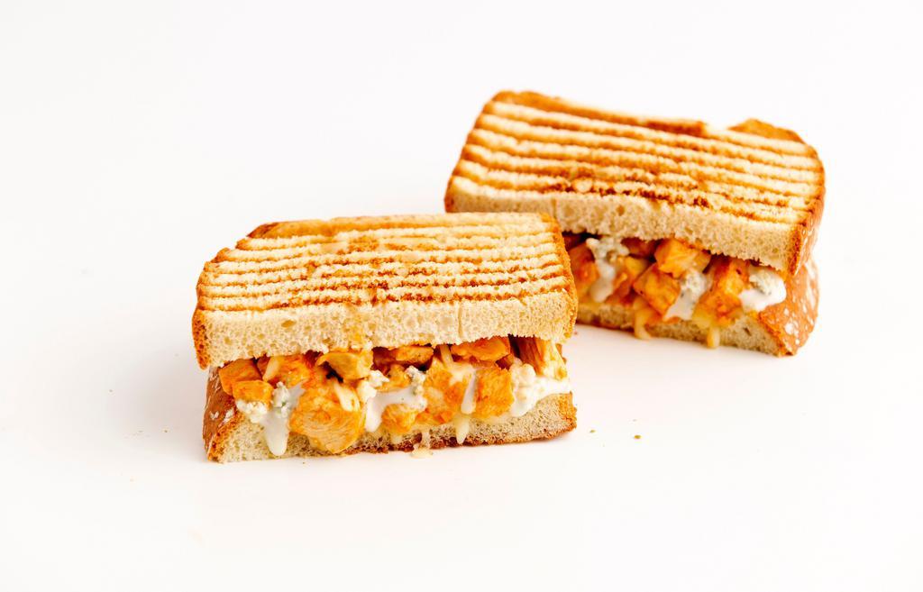 Buffalo Chicken Panini · Chicken, provolone cheese, and spicy buffalo sauce with blue cheese dressing. Served on grilled sourdough bread.