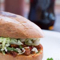 Torta · A Mexican sandwich that includes beans, lettuce, tomato, sour cream, cheese and your choice ...