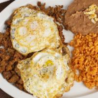Steak & Eggs · Two eggs over easy with Steak served with a side of Rice and Beans w/ tortillas on the side