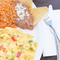 Huevos A La Mexicana · Two scrambled eggs with grilled onion, green pepper, and tomato served with rice, beans and ...