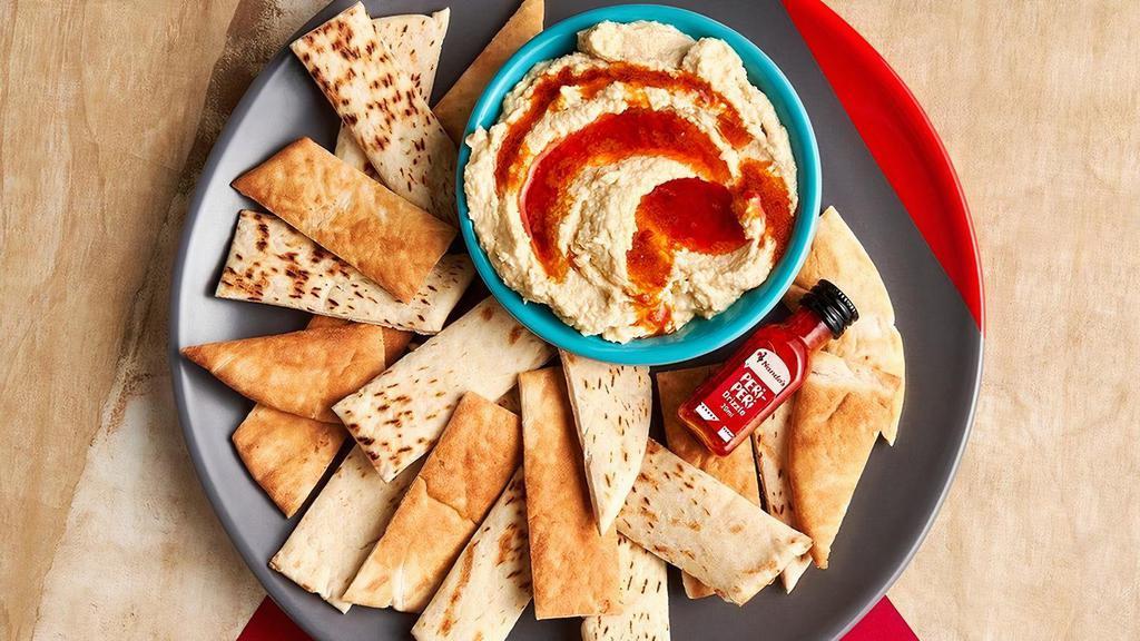 Hummus With Peri-Peri Drizzle · PERi-PERi-infused oil poured over creamy hummus. Dig in with toasted pita or crunchy seasonal vegetables.
