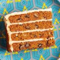 Carrot Cake · Four rich, golden layers of cake with walnuts, pineapple and raisins. Topped with a smooth c...