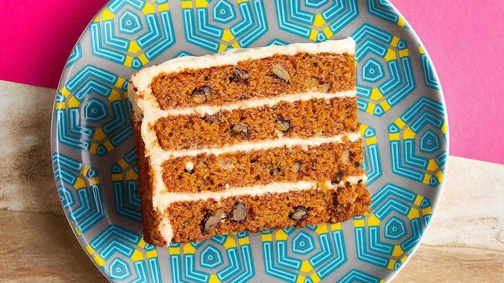 Carrot Cake · Four rich, golden layers of cake with walnuts, pineapple and raisins. Topped with a smooth cream cheese icing.