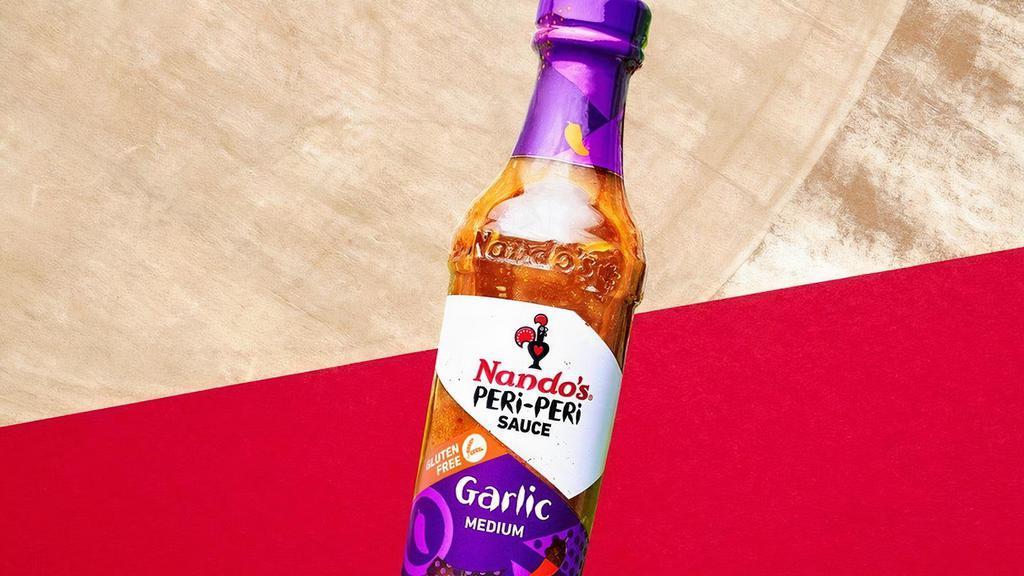 Bottle Sauce Garlic · Garlic is many things, but it isn't subtle.  Just like this sauce, a blend of PERi-PERi with its sweet waves of garlicky goodness.  If you're on a first date, pour this on both of your plates.  You'll thank us later.