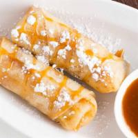 Banana Egg Roll (2) · Coconut sugar dusted banana rolled in egg roll wrapper, caramel syrup topped