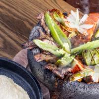 Molcajete · Arroyo molcajete (chicken or steak) served with our roasted salsa, grilled chorizo, grilled ...