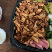 Chicken Shawarma Bowl · Vertically roasted chicken shawarma on a bed of either rice, lettuce, hummus, or fries serve...