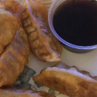 Fried Dumpling (8 Pieces) · Top menu item. Fried dumplings stuffed with pork, cabbage, and onion, laid on a bed of icebe...