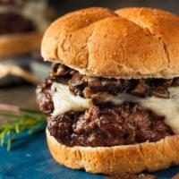 Smothered Burger · Juicy half pound beef patty topped with mushrooms, melted cheese, and onions layered between...
