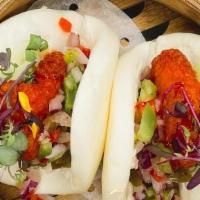 Spicy Chicken Bao Bun · Fried chicken tossed in sriracha honey with pickled jalapeno & pepper mix