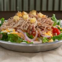 Pulled Pork Salad · Crisp romaine lettuce garnished with red onion bacon tomato shredded cheese and then topped ...